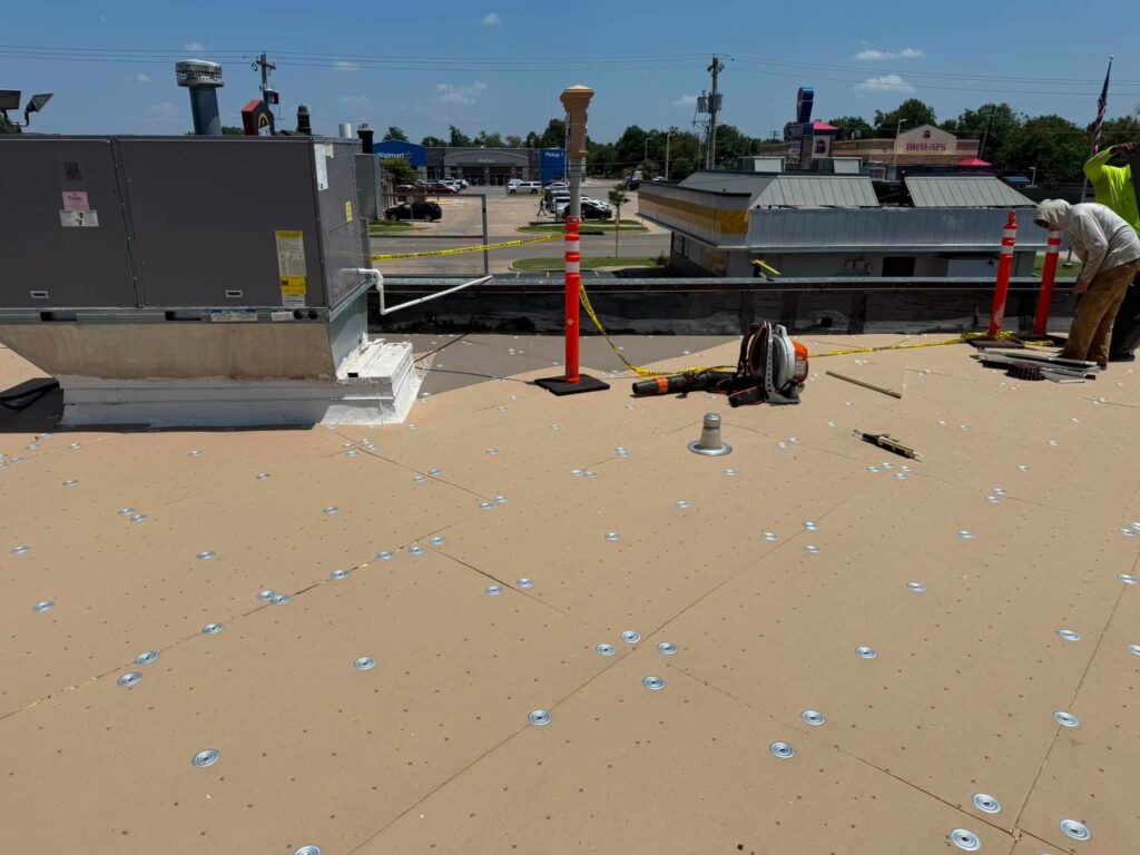 Commercial Flat Roof — Tree & Water Tower — photo 2
